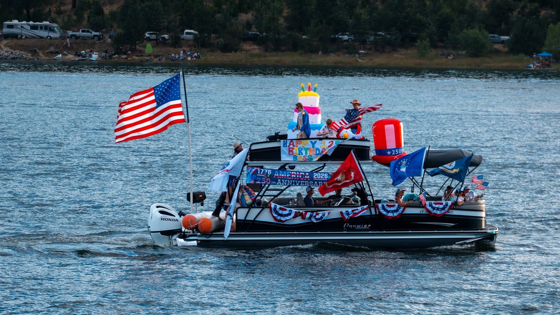 Pontoon boat buying guide: a modern double-decker pontoon boat cruising a lake full of passengers